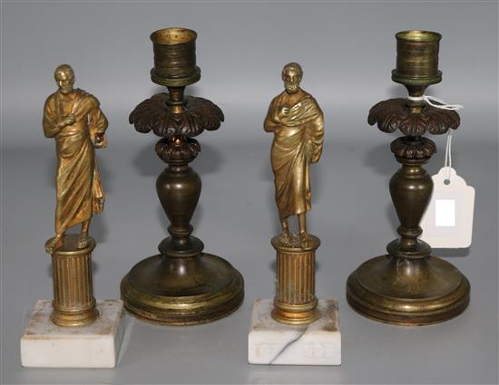 A pair of bronze candlesticks and a pair of classical figures